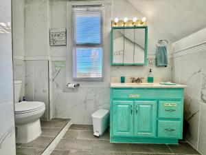 a bathroom with a blue cabinet and a toilet at Private Room with Shared Amenities 10 Minutes to Airport and Walking Distance to Bus Station in Seattle +38 photos