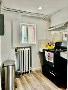 a kitchen with a stove and a radiator at Private Room with Shared Amenities 10 Minutes to Airport and Walking Distance to Bus Station in Seattle