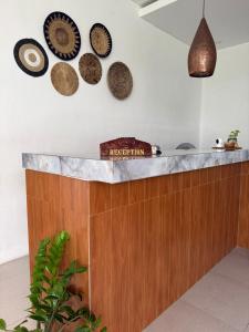 a kitchen with a counter with plates on the wall at Santai Suites Nusa Dua in Nusa Dua +117 photos