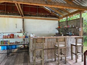 an outdoor bar in a building with stools at Naks Shack in Koh Ta kiev Island