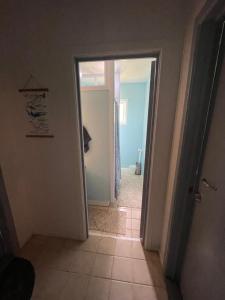 a hallway with a door open to a bathroom at Fuaamotu Airport Overnight Stay and Catch Your Flight ! in Fua‘amotu
