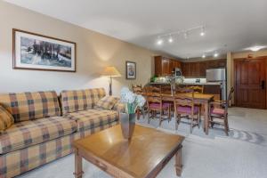 a living room with a couch and a table at 3309 - Two Bedroom Standard Powderhorn Lodge condo in Solitude