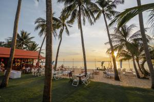 a restaurant on the beach with palm trees at Sea Star Resort in Phú Quốc