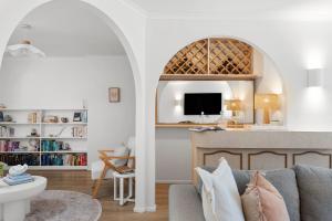 a living room with a couch and a tv at Salty Waves Escape at Jervis Bay - 3BR relaxed beach side living in Vincentia