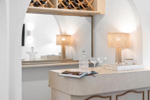 a table with two lamps and a book and a mirror at Salty Waves Escape at Jervis Bay - 3BR relaxed beach side living in Vincentia +34 photos