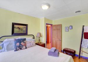 a bedroom with a bed with a phone on it at Historic Downtown Gettysburg Entire Home with Free Parking in Gettysburg