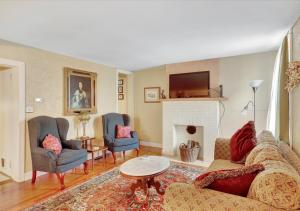 a living room with a couch and chairs and a fireplace at Historic Downtown Gettysburg Gem in Gettysburg