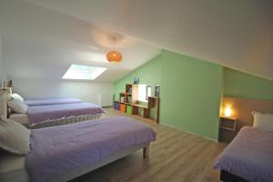a room with three beds with purple blankets at Chez marie-louise in Fromental +47 photos