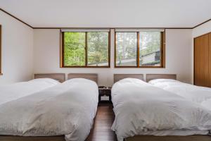 Postel nebo postele na pokoji v ubytování T&A Resort&Sauna KARUIZAWA