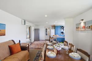 a living room with a table and a couch at Toad Hall - Akaroa Holiday Home in Akaroa