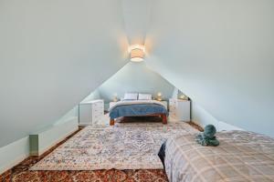 a bedroom with two beds in a attic at Toad Hall - Akaroa Holiday Home in Akaroa