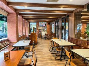 a dining room with tables and chairs in a restaurant at All Nite & Day Kebon Jeruk in Jakarta