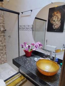 a bathroom with a sink and a bowl on a counter at Casa Temporada in Porto Seguro