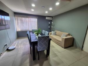 a living room with a table and a couch at Casa Lupe - Con Piscina Climatizada in Las Heras