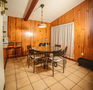 a dining room with a table and chairs at Cabaña Traslomita in Mazamitla +22 photos