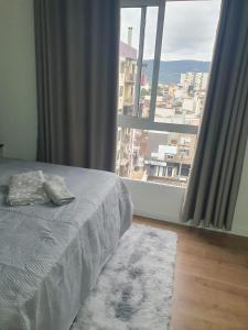 a bedroom with a bed and a large window at Full Studio in Santa Maria in Santa Maria