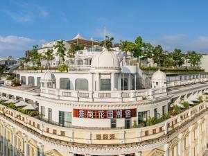 an ornate white building with trees on top of it at Vishan Garden Boutique Hotel 厦门维尚花园潮宿 中山路步行街店 in Xiamen