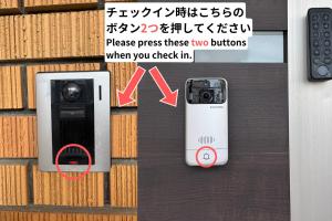 a picture of a cell phone next to a wall at Guest House FUKUMIMI in Miyazaki