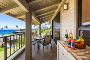 a porch with a table and a view of the ocean at Kapalua Bay Villas 32B4 · KBV 32B4 Oceanfront Kapalua Spectacula in Kahana