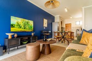 a living room with a couch and a table at Relax Wena in Fourways