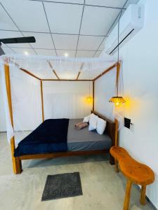 a bedroom with a bed with a person laying on it at Crystal Wave in Weligama