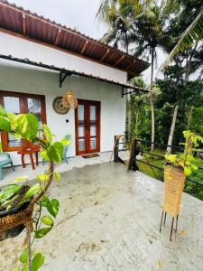 a patio of a house with a house at Crystal Wave in Weligama