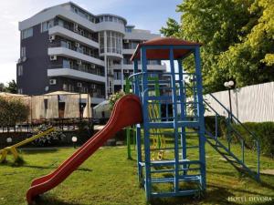 a playground with a slide in a park at Apatcomplex Diva &restaurant&bar in Saints Constantine and Helena
