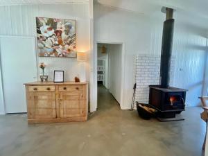 a living room with a fireplace and a wood stove at Robe's Hidden Gem - WiFi Pet Friendly Outside in Robe +24 photos