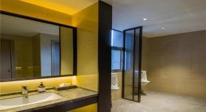 a bathroom with a sink and a large mirror at Echeng Hotel Changsha Evening News in Changsha +43 photos