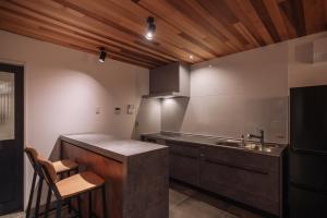 a kitchen with a counter and a sink and a counter top at Sanctuary Villa & Sauna Ogimi by Relapool in Banchi +28 photos