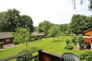 a view from the balcony of a house with a yard at La Boverie in Rendeux