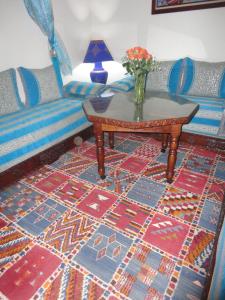 a living room with a couch and a table at Dar Yanis in Rabat