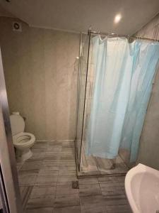 a bathroom with a shower with a toilet and a sink at Apartaments Diva in Varna City
