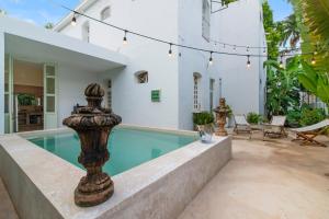 a swimming pool in the backyard of a house at Casa Damiana, Colonial Charm with Private Pool in Mérida