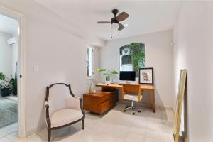 an office with a desk with a computer and a chair at Casa Damiana, Colonial Charm with Private Pool in Mérida