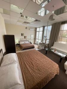 a bedroom with a large bed in a room with windows at Apatcomplex Diva &restaurant&bar in Saints Constantine and Helena +80 photos