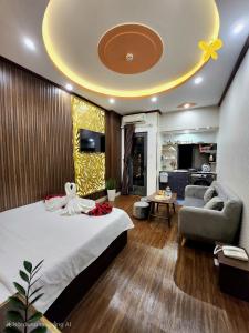 a bedroom with a large bed and a living room at HA Hotel & Apartment in Vung Tau