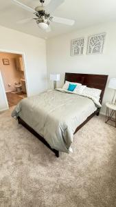 a bedroom with a large bed with a ceiling fan at Oasis Lakeside place Near Frisco 2bd-2ba Sleep 6 in Aubrey +14 photos