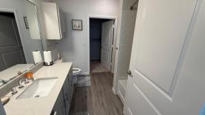 a white bathroom with two sinks and a mirror at Oasis Lakeside place Near Frisco 2bd-2ba Sleep 6 in Aubrey