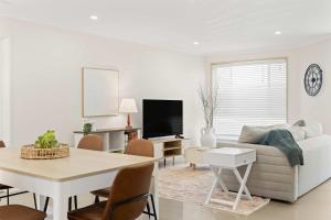 a living room with a couch and a table at Buddina Bliss - Pet Friendly Holiday Home in Buddina