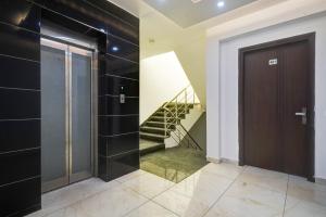 a hallway with a door and a staircase at Hotel King Near Delhi Airport in New Delhi