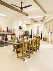 a dining room with a large table and chairs at Dzukou Lodge in Kohīma