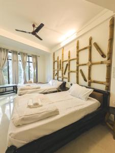 a room with three beds and a ceiling at Dzukou Lodge in Kohīma +23 photos