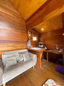 a living room with a couch and a desk at Villa Iraa in Dieng