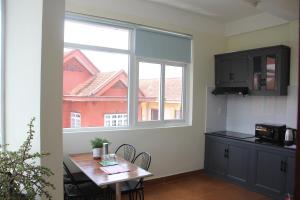 a kitchen with a table and a large window at Thu Van Apartment in Xuan An +42 photos