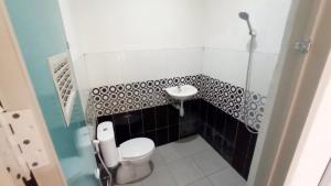 a small bathroom with a toilet and a sink at House of A Syariah Kedamaian in Bandar Lampung