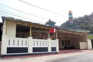 a building with a white fence in front of it at House of A Syariah Kedamaian in Bandar Lampung