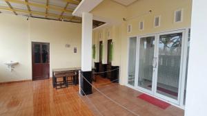 a room with a porch with a table on the floor at House of A Syariah Kedamaian in Bandar Lampung +9 photos