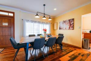 a dining room with a table and chairs at StayAU Riverfront Paradise Pet-friendly Tasmania in Beauty Point