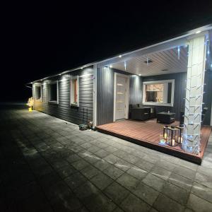 a house with a wooden deck at night at Aurora Haven in Vanttauskoski